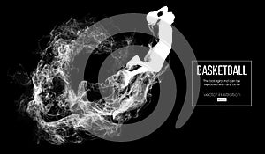 Abstract silhouette of a basketball player on dark black background. Basketball player jumping and performs slam dunk.