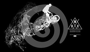 Abstract silhouette of a bmx rider on the dark, black background from particles. Bmx rider jumps and performs the trick.