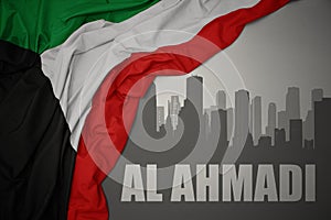 Abstract silhouette of the city with text Al Ahmadi near waving national flag of kuwait on a gray background photo