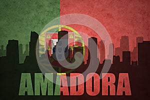 Abstract silhouette of the city with text Amadora at the vintage portuguese flag