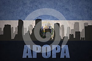 Abstract silhouette of the city with text Apopa at the vintage salvadoran flag