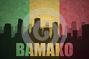 Abstract silhouette of the city with text Bamako at the vintage malian flag