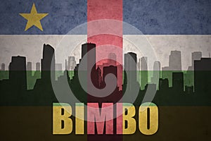 Abstract silhouette of the city with text Bimbo at the vintage central african republic flag photo