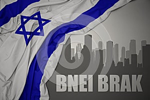 Abstract silhouette of the city with text Bnei Brak near waving national flag of israel on a gray background.3D illustration photo