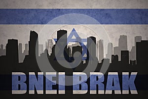 Abstract silhouette of the city with text Bnei Brak at the vintage israel flag