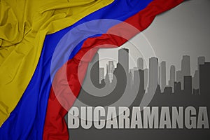 Abstract silhouette of the city with text Bucaramanga near waving national flag of colombia on a gray background photo