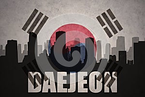 Abstract silhouette of the city with text Daejeon at the vintage south korea flag