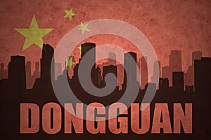 Abstract silhouette of the city with text Dongguan at the vintage chinese flag