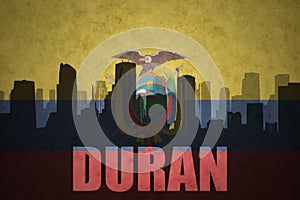 Abstract silhouette of the city with text Duran at the vintage ecuadorian flag