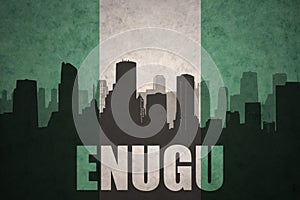 Abstract silhouette of the city with text Enugu at the vintage nigerian flag