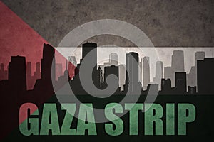 Abstract silhouette of the city with text Gaza Strip at the vintage palestinian flag