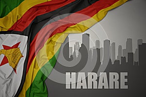 Abstract silhouette of the city with text Harare near waving colorful national flag of zimbabwe on a gray background