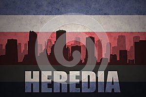 Abstract silhouette of the city with text Heredia at the vintage costa rican flag photo