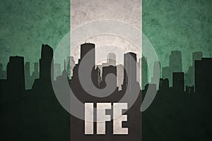 Abstract silhouette of the city with text Ife at the vintage nigerian flag