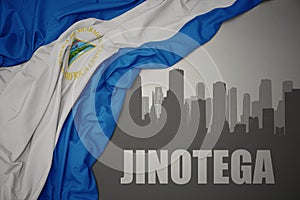 Abstract silhouette of the city with text Jinotega near waving national flag of nicaragua on a gray background. 3D illustration photo