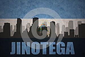 Abstract silhouette of the city with text Jinotega at the vintage nicaraguan flag photo