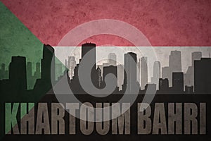 Abstract silhouette of the city with text Khartoum Bahri at the vintage sudanese flag