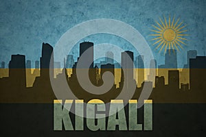 Abstract silhouette of the city with text Kigali at the vintage rwandan flag