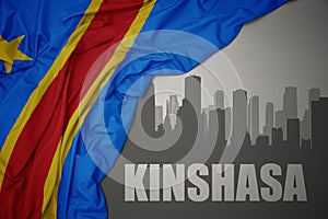 Abstract silhouette of the city with text Kinshasa near waving colorful national flag of democratic republic of the congo on a