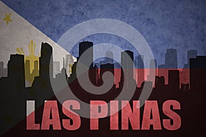 Abstract silhouette of the city with text Las Pinas at the vintage philippines flag