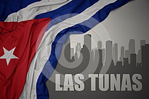 Abstract silhouette of the city with text Las Tunas near waving national flag of cuba on a gray background. 3D illustration