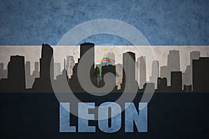 Abstract silhouette of the city with text Leon at the vintage nicaraguan flag