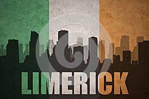 Abstract silhouette of the city with text Limerick at the vintage irish flag