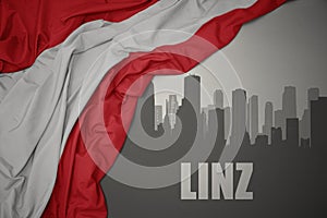 Abstract silhouette of the city with text Linz near waving national flag of austria on a gray background