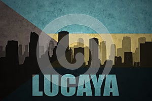 Abstract silhouette of the city with text Lucaya at the vintage bahamas flag