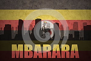 Abstract silhouette of the city with text Mbarara at the vintage ugandan flag
