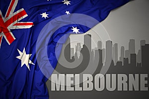 Abstract silhouette of the city with text Melbourne near waving national flag of australia on a gray background