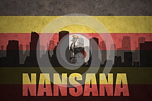 Abstract silhouette of the city with text Nansana at the vintage ugandan flag