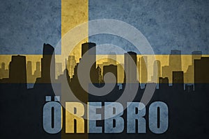 Abstract silhouette of the city with text Orebro at the vintage swedish flag