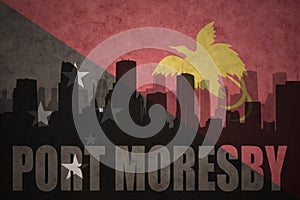 Abstract silhouette of the city with text Port Moresby at the vintage Papua New Guinea flag