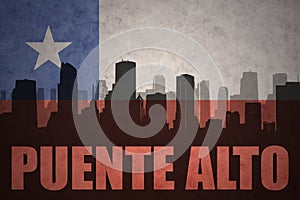 Abstract silhouette of the city with text Puente Alto at the vintage chilean flag