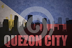 Abstract silhouette of the city with text Quezon City at the vintage philippines flag