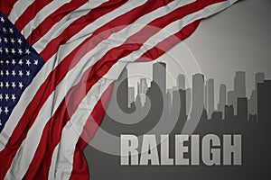 Abstract silhouette of the city with text Raleigh near waving colorful national flag of united states of america on a gray