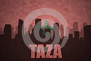 Abstract silhouette of the city with text Taza at the vintage moroccan flag photo