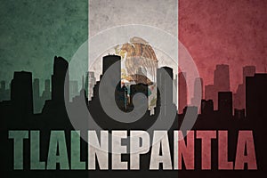 Abstract silhouette of the city with text Tlalnepantla at the vintage mexican flag photo