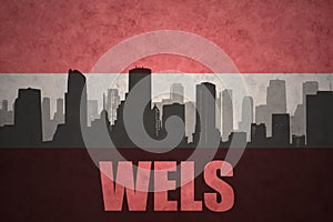 Abstract silhouette of the city with text Wels at the vintage austrian flag