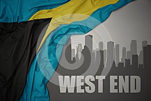 Abstract silhouette of the city with text West End near waving national flag of bahamas on a gray background. 3D illustration