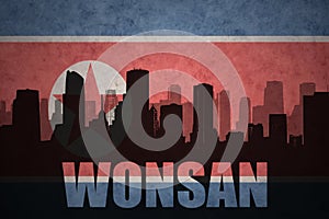 Abstract silhouette of the city with text Wonsan at the vintage north korea flag