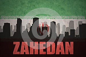 Abstract silhouette of the city with text Zahedan at the vintage iranian flag photo