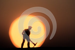 Abstract,silhouette Model people mining on sky sunset background.