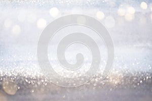 Abstract silver glitter bokeh lights with soft light background