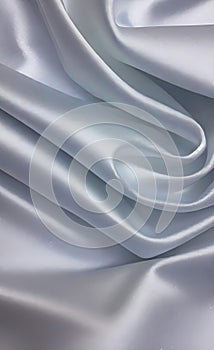 Abstract smooth elegant white fabric silk texture soft background, flowing satin waves. Gray, silver fabric silk texture close up.