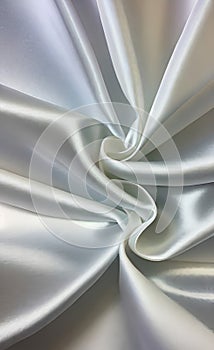 Abstract smooth elegant white fabric silk texture soft background, flowing satin waves. Gray, silver fabric silk texture close up.