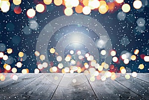 Abstract Snowy Christmas Background. Wooden Table With Defocused Lights