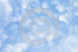 Abstract soft light blue background with blurred circles. Small clouds on a sunny day.