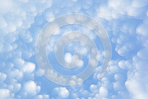 Abstract soft light blue background with blurred circles. Small clouds on a sunny day.